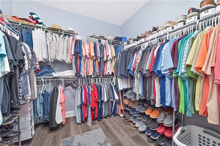 Walk in closet featuring dark wood-style flooring