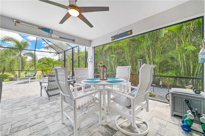 Sunroom / solarium featuring a patio area, ceiling fan, and outdoor dining space