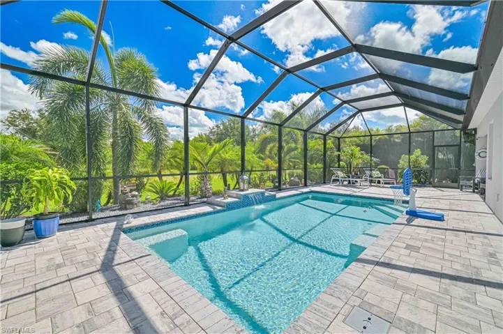 Swimming pool with a lanai, a patio area, and a sunroom
