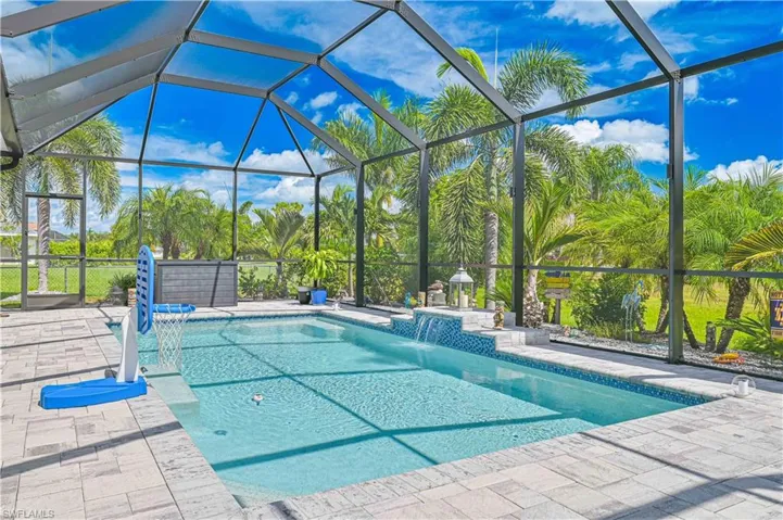 Outdoor pool with a sunroom, a lanai, and a patio area