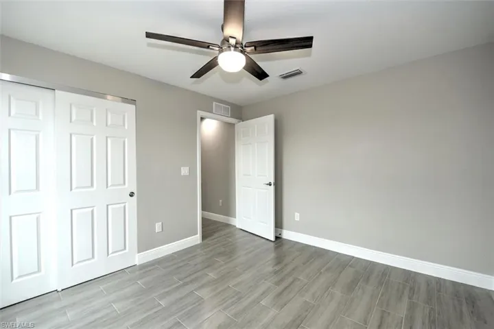 Unfurnished bedroom with a closet and ceiling fan