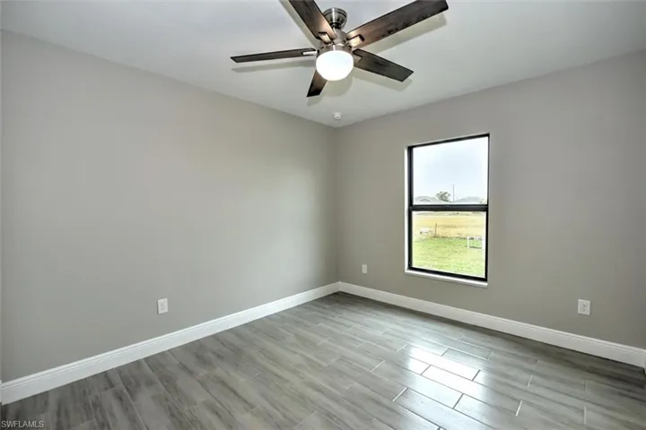 Spare room with light wood-type flooring and ceiling fan