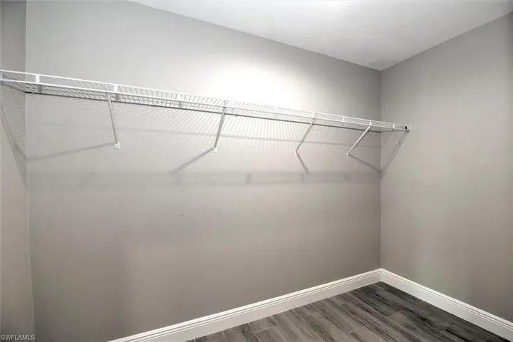 Spacious closet with wood-type flooring