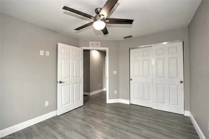 Unfurnished bedroom with a closet and ceiling fan