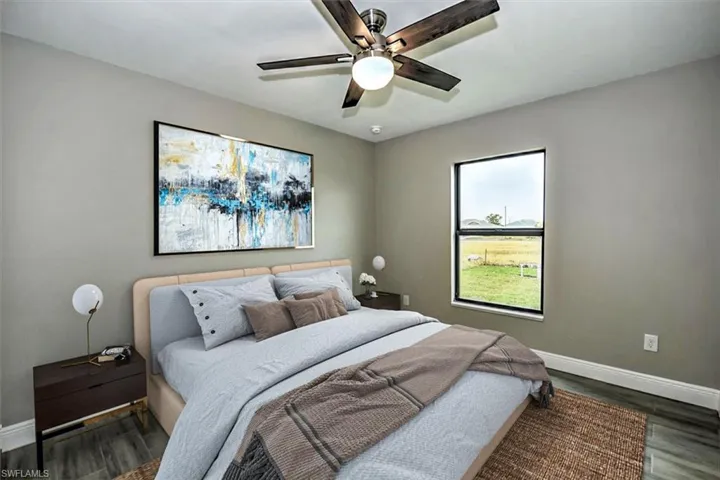 Bedroom featuring dark hardwood / wood-style flooring and ceiling fan