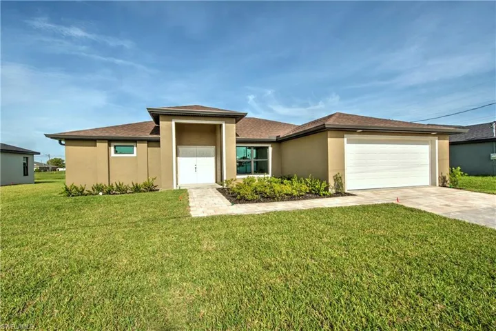 Prairie-style home featuring a garage and a front lawn