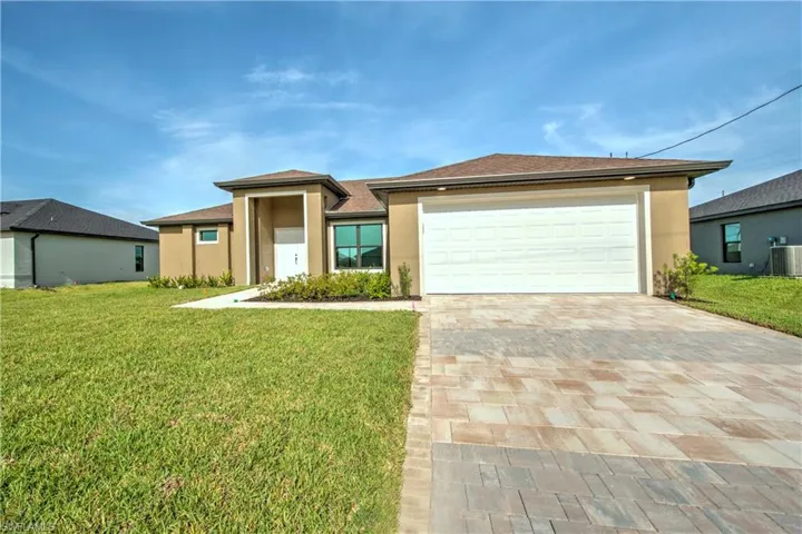 Prairie-style home with cooling unit, a garage, and a front lawn