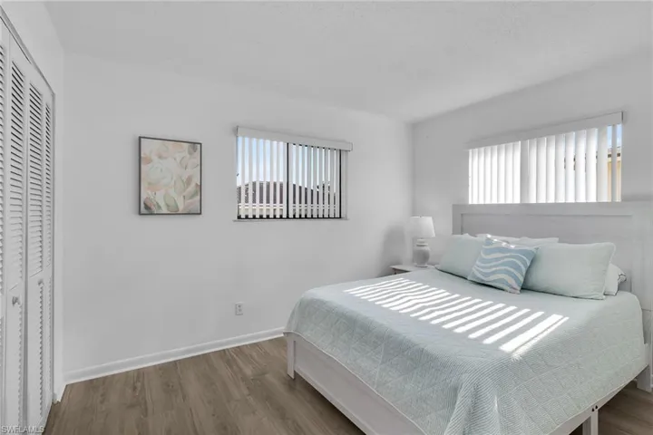 Bedroom featuring wood finished floors, a closet, and a textured ceiling