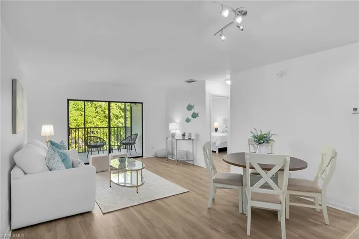 Living area with light wood-style flooring and baseboards