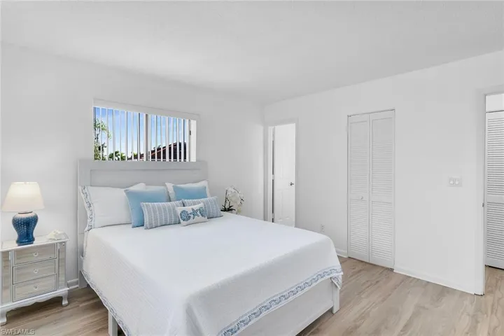 Bedroom with light wood-type flooring and a closet