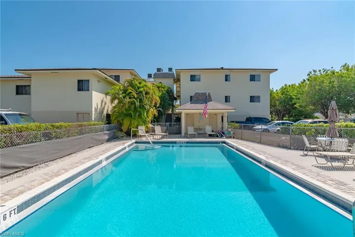 Community pool with a patio area and a gazebo