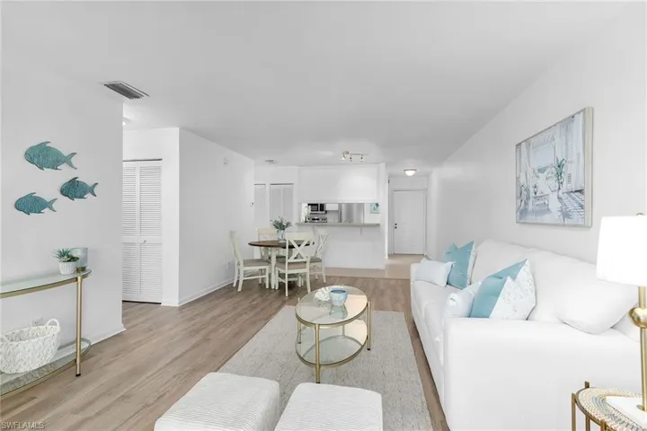Living room with light wood-type flooring and baseboards
