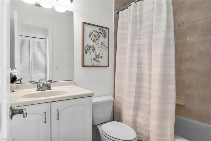 Full bathroom featuring vanity and shower / bath combination with curtain