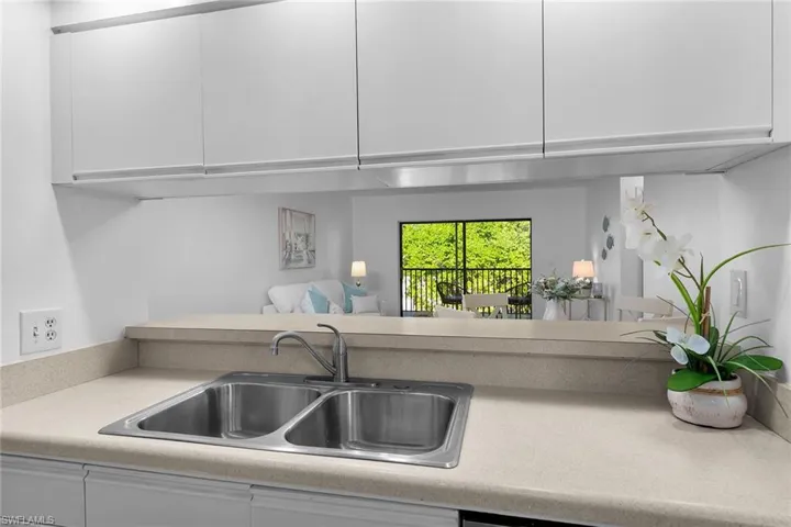 Kitchen with white cabinets, light countertops, open floor plan, and modern cabinets