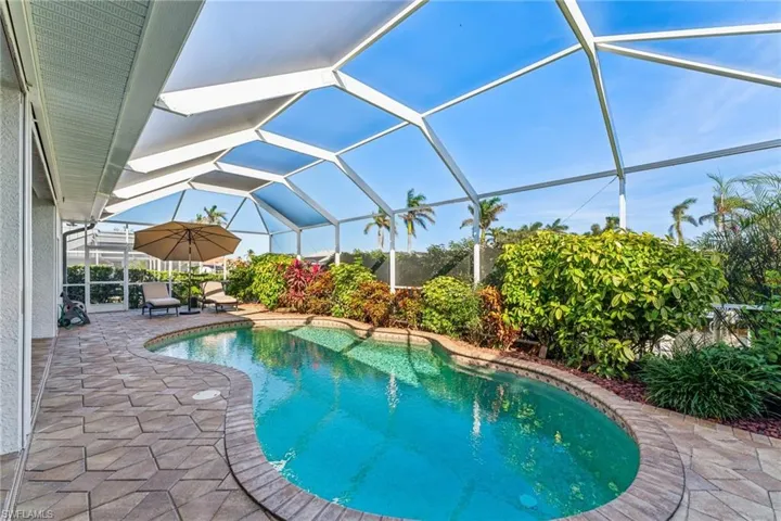 View of swimming pool with a lanai and a patio