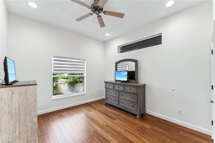Unfurnished bedroom with hardwood / wood-style floors and ceiling fan
