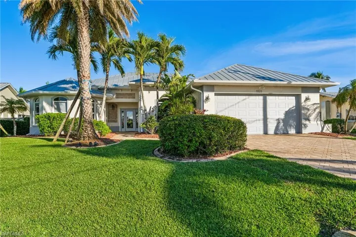 Single story home featuring french doors, a garage, and a front yard