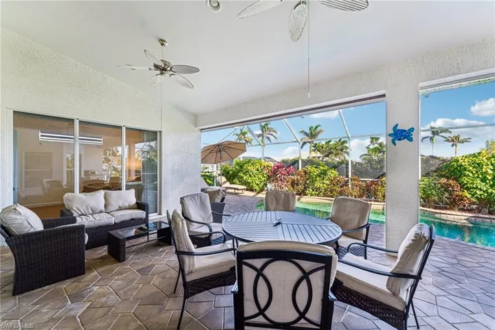 Sunroom featuring ceiling fan vaulted ceiling