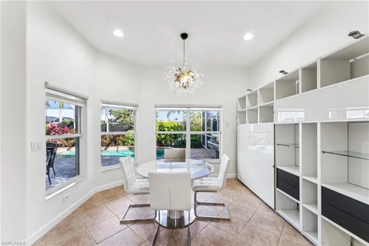 Dining room with light tile patterned floors and a chandelier