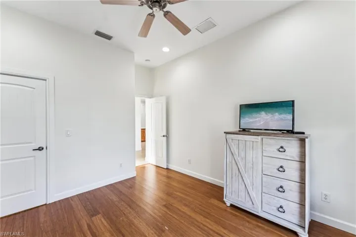 Unfurnished bedroom with hardwood / wood-style flooring and ceiling fan
