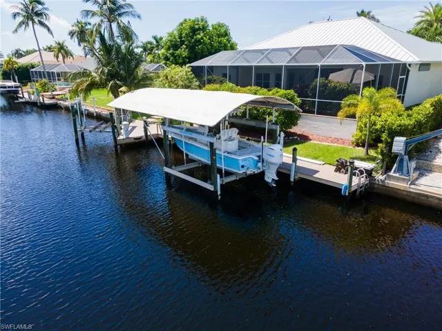 View of dock featuring a water view and a lanai