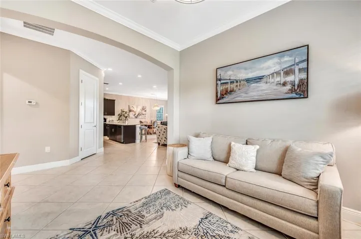 Tiled living room featuring ornamental molding