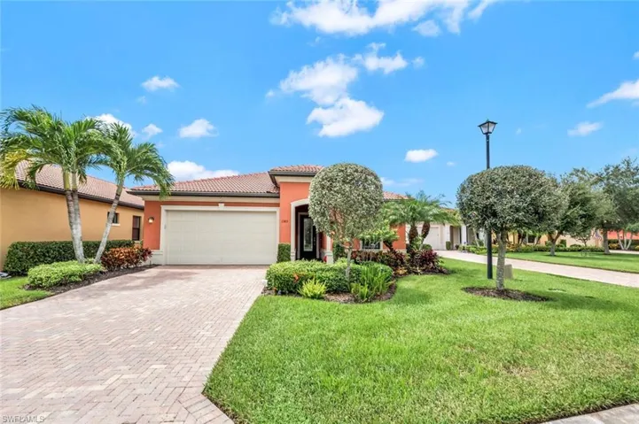 Mediterranean / spanish-style home with a front yard and a garage