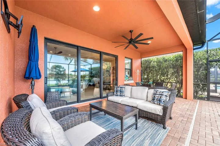 View of patio with outdoor lounge area and ceiling fan