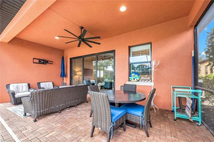 View of patio with an outdoor hangout area and ceiling fan