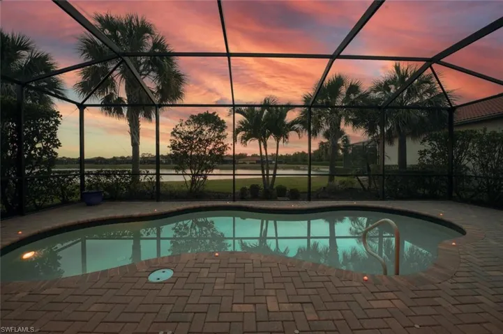 Outdoor pool with a lanai and a patio area