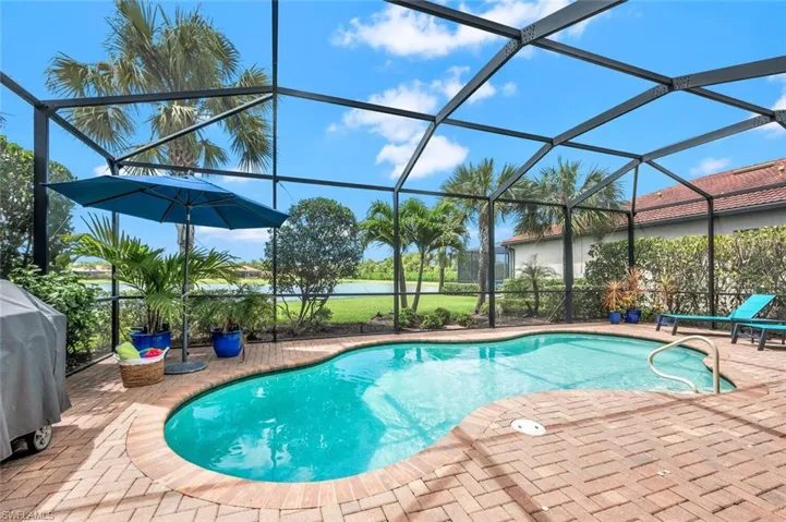 View of pool with a lanai and a patio