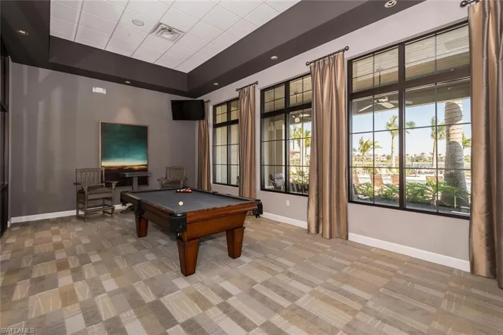 Playroom featuring light colored carpet, pool table, and a raised ceiling