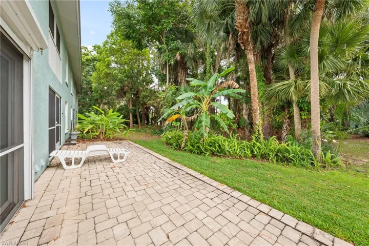 Paved patio area featuring light-colored pavers in a herringbone pattern