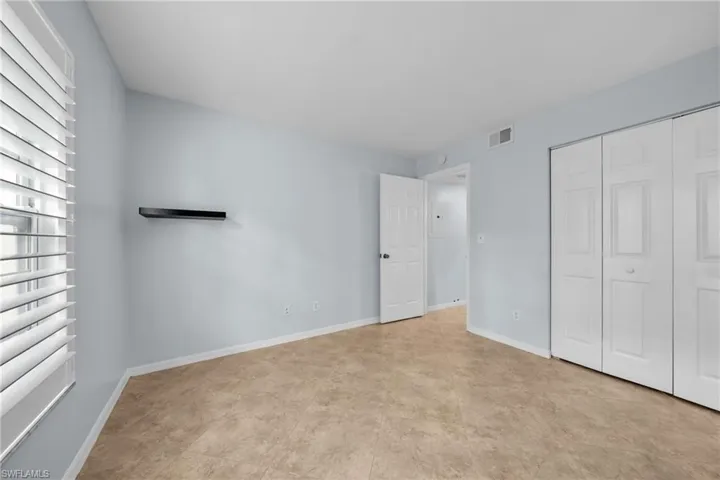 Interior room featuring light blue walls and wood-finish flooring