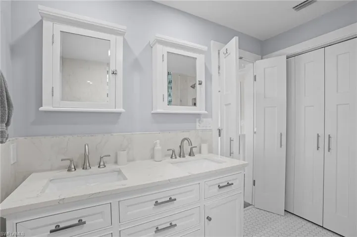 Bathroom featuring double vanity, a sink, and visible vents. Virtually Edited Image