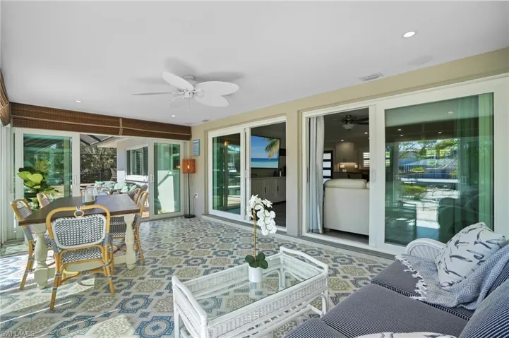 Sunroom with ceiling fan and visible vents. Virtually Edited Image
