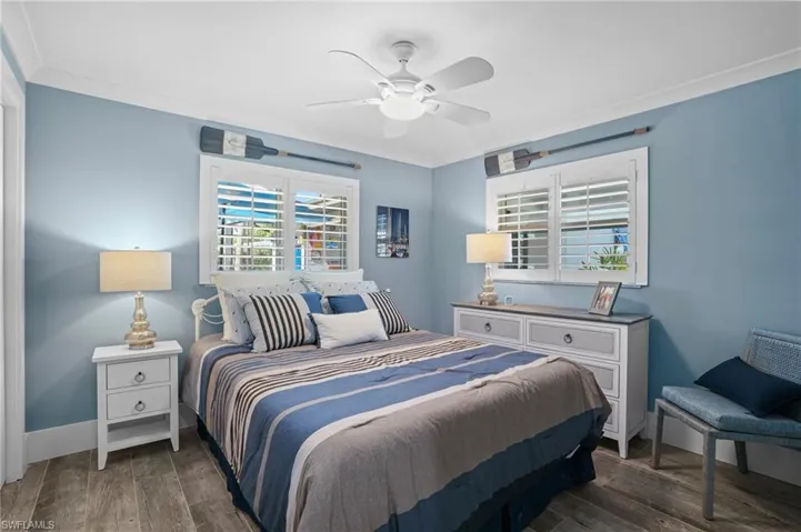 Bedroom featuring baseboards, ornamental molding, dark