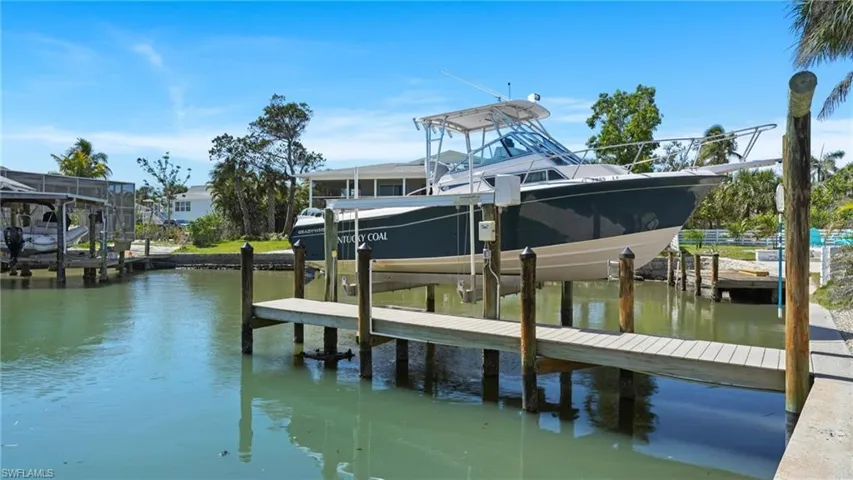 Dock area with a water view and boat lift - Virtually Edited Image