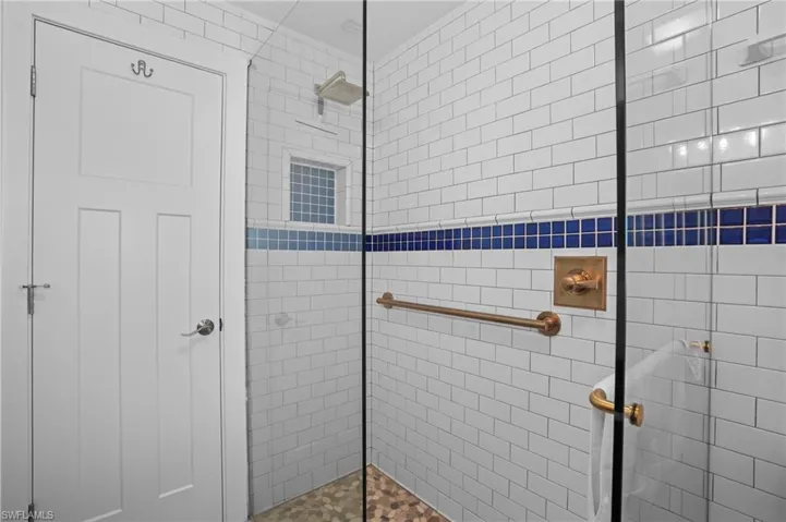 Bathroom featuring tiled shower. Virtually Edited Image