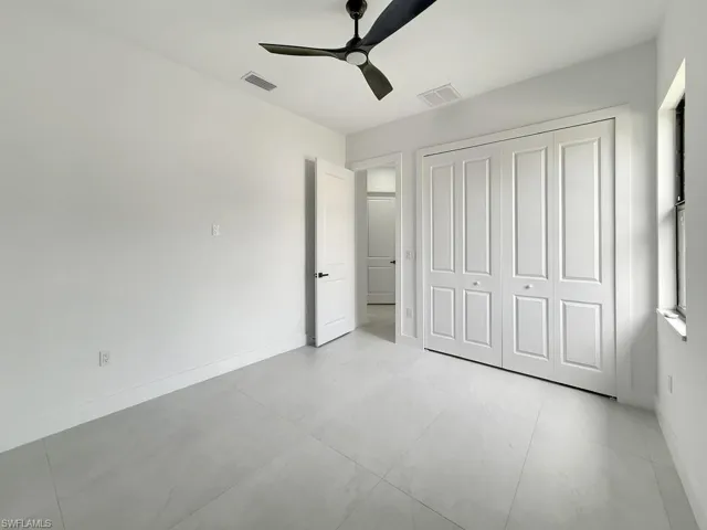 Unfurnished bedroom featuring a ceiling fan and a closet