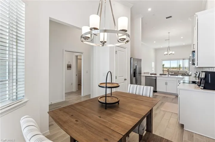 Dining area featuring a chandelier, wood finish floors, and recessed lighting