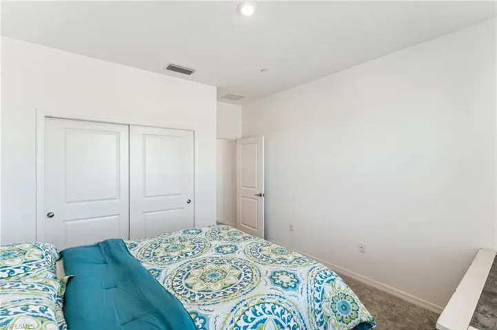 Bedroom featuring carpet floors and a closet