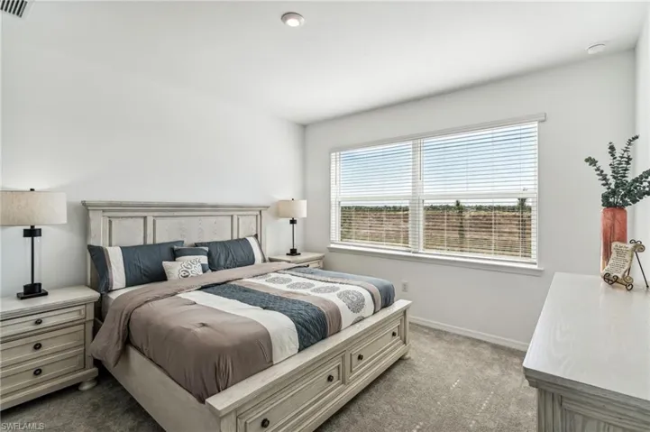 Bedroom featuring carpet flooring and baseboards