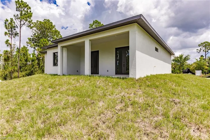 Back of property featuring a lawn