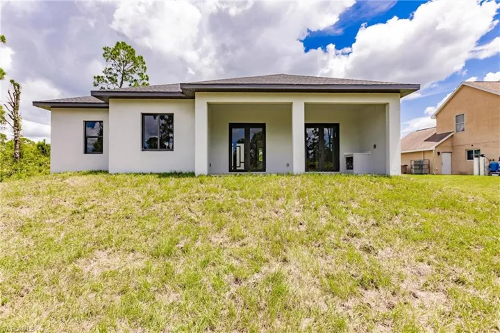 Back of house featuring a lawn