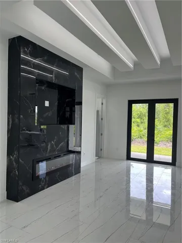 Living room with tile patterned flooring and french doors