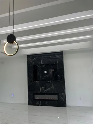 Details featuring tile patterned flooring and a high end fireplace
