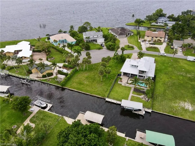 Birds eye view of property with a water view
