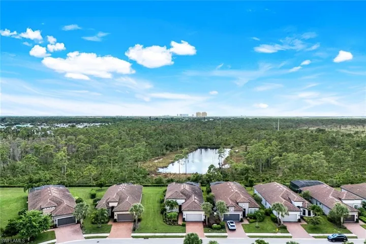 Aerial perspective of suburban area featuring a large body of water