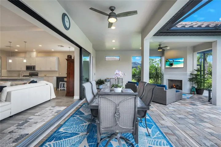 Dining space featuring arched walkways, light wood-style flooring, and recessed lighting